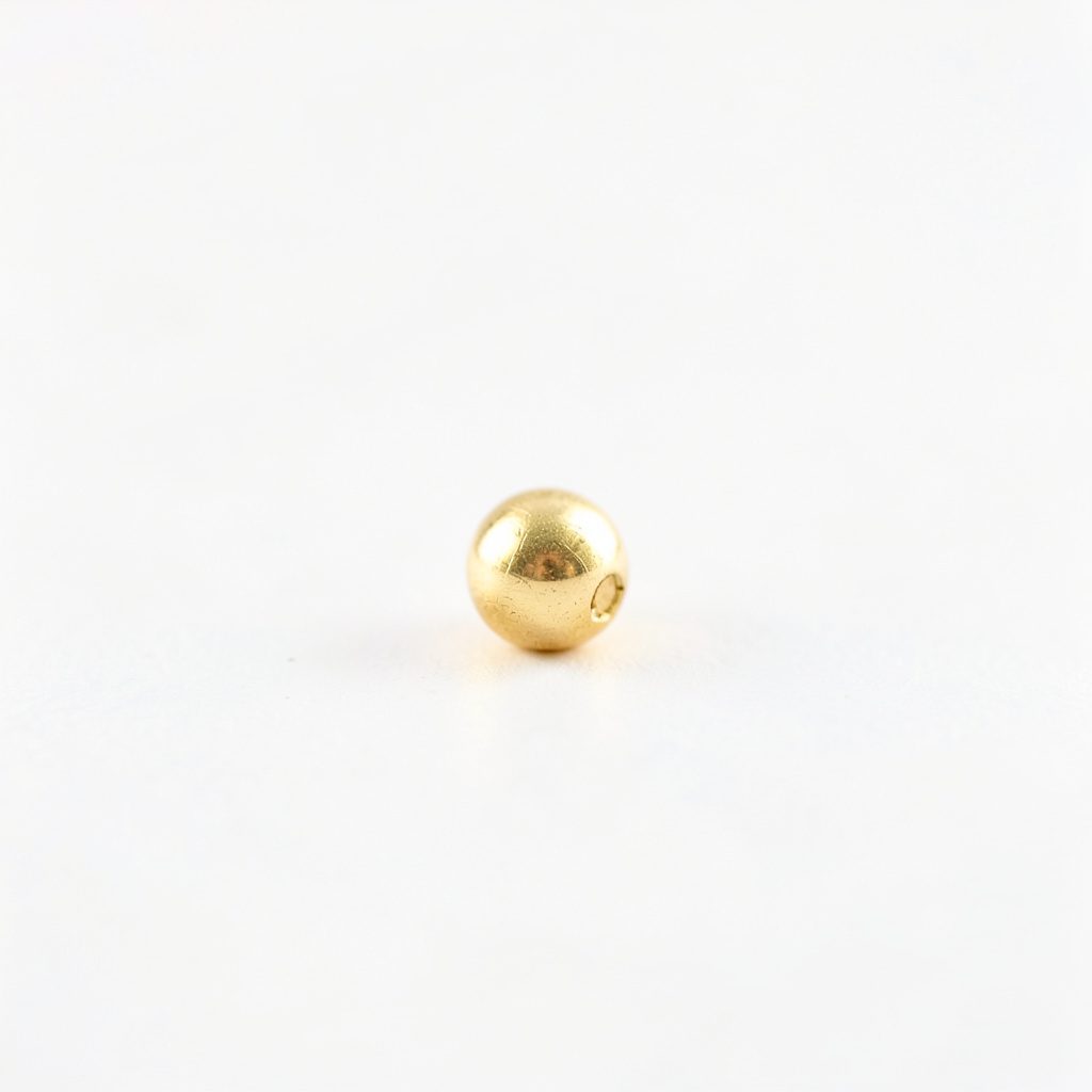 A gold nugget photographed closely against a plain background